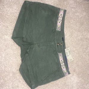 Green shorts with pink belt